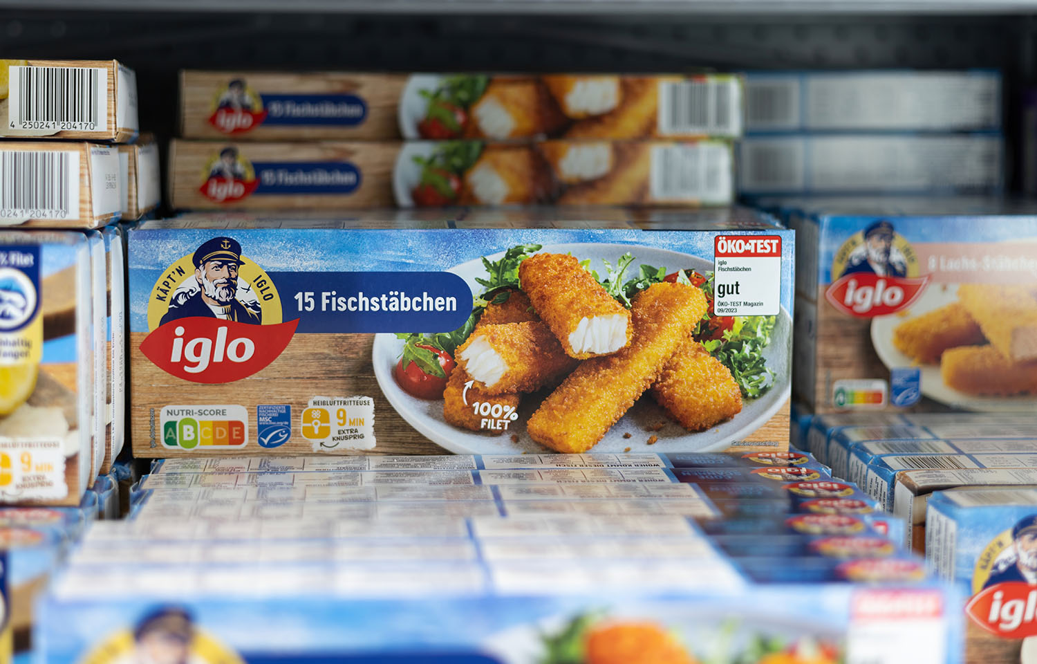 A grocery store refrigerated case containing iglo brand fish sticks