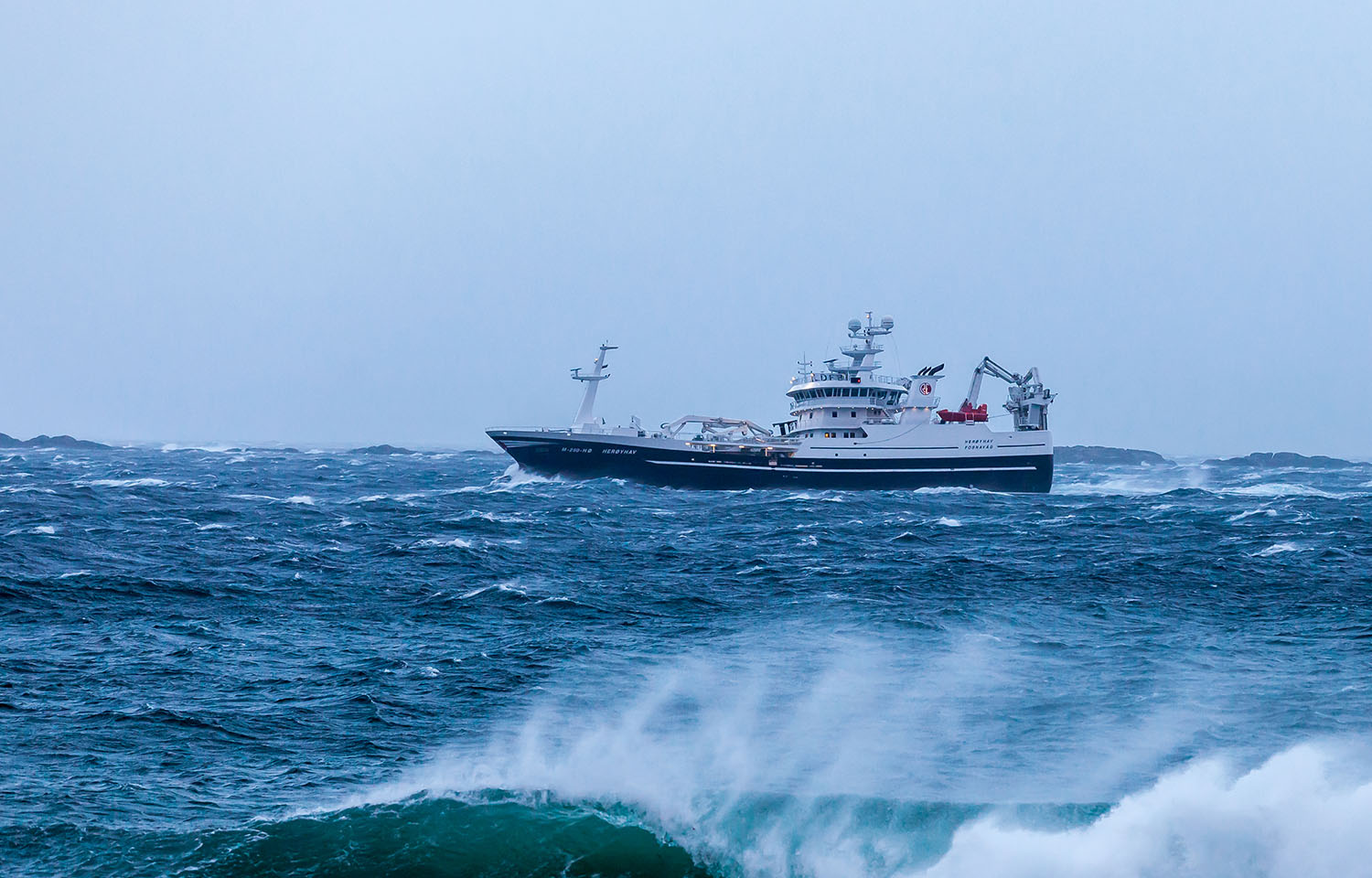 A fishing boat in rough seas off the coast of Norway