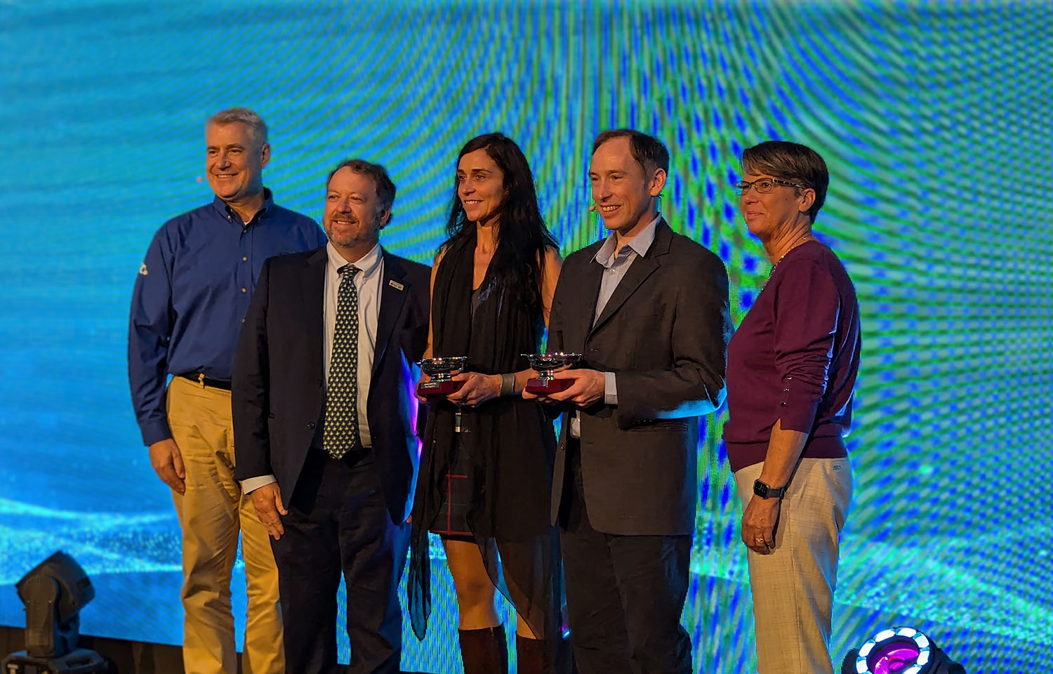 The two winners of the Responsible Seafood Innovation Awards stand on stage in St. Andrews, Scotland