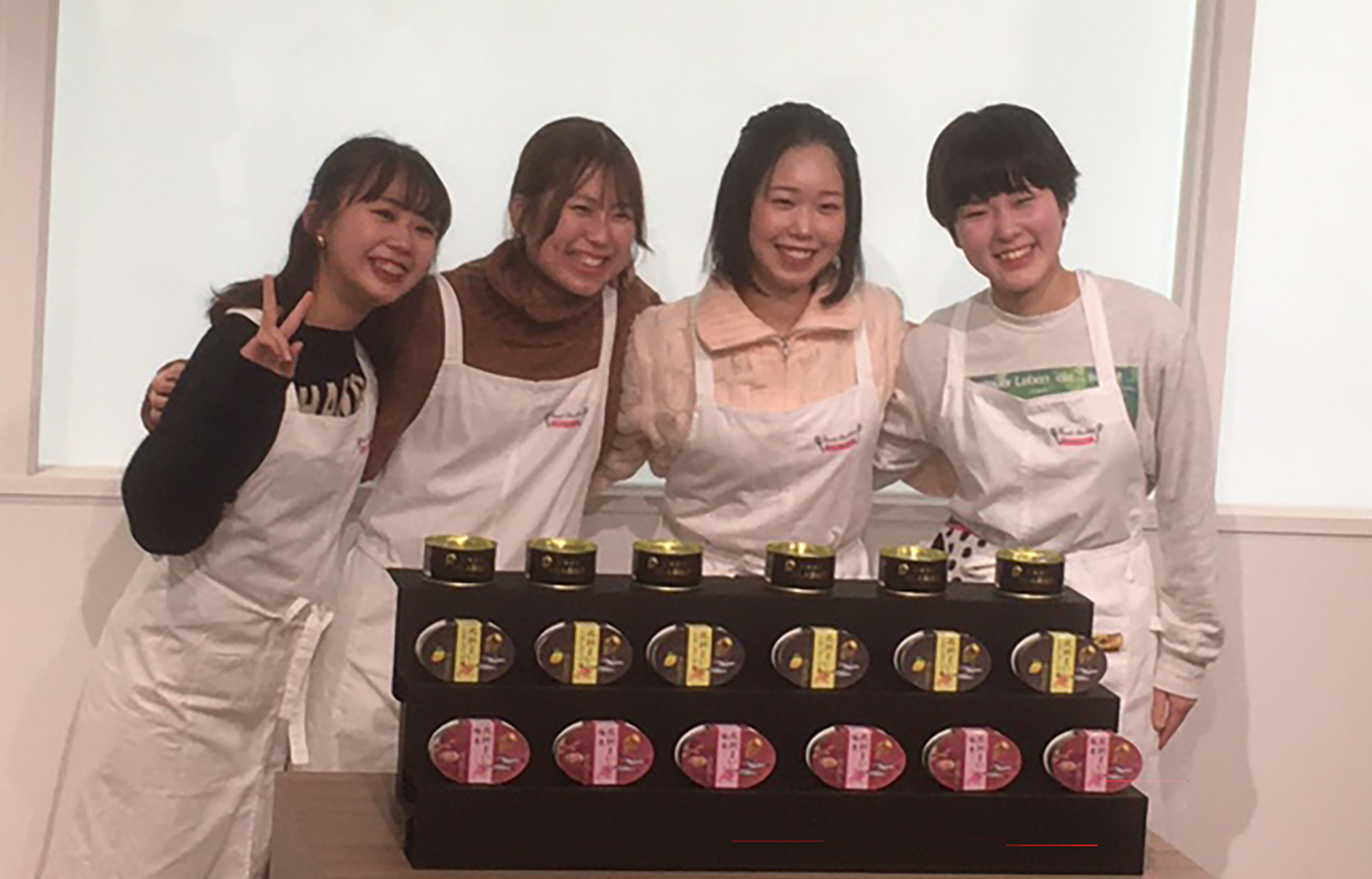 Students at the Shoin Women's College displaying new products created through a partnership with Maruha Nichiro