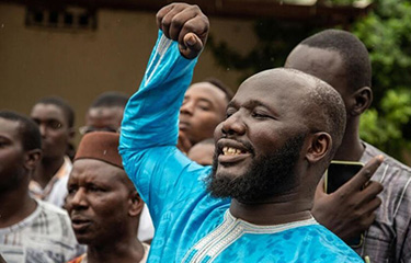 Members of the Taxawu Cayar Collective protest in front of Senegal's High Court.