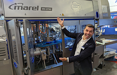 Marel Global Sales Director Diego Lages showing off the company's new MS 2750 salmon filleting machine.