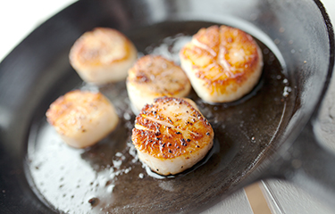 Scallops being cooked.