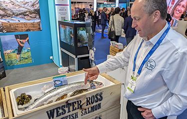 James "Gilpin" Bradley showcasing one of the company's salmon at Seafood Expo Global in Barcelona, Spain.