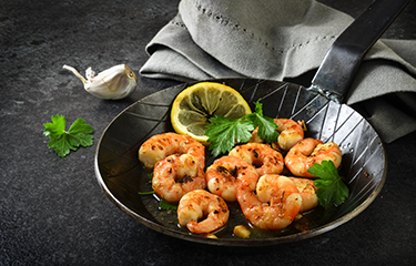 A plate of cooked shrimp.