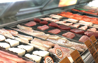 A seafood counter in the U.S. featuring fillets of several different species of fish.