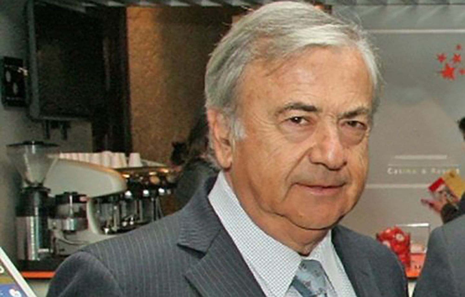 Former Australis owner Isidoro Quiroga, wearing a grey suit.