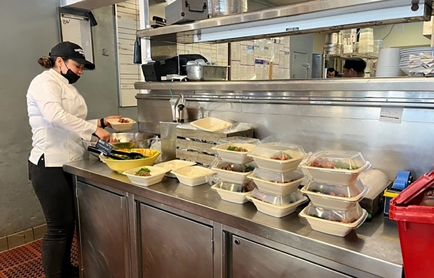 A Santa Monica Seafood employee preparing meals for victims of the Los Angeles area fires