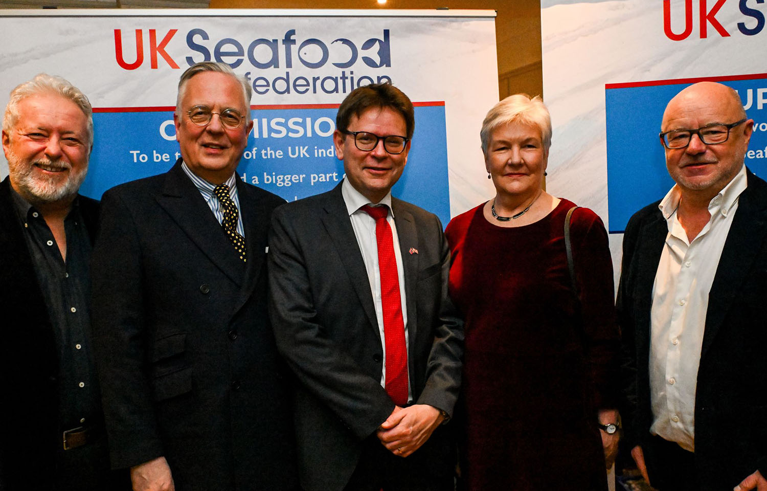 Members of the UK Seafood Federation in front of a banner featuring the new organization's logo
