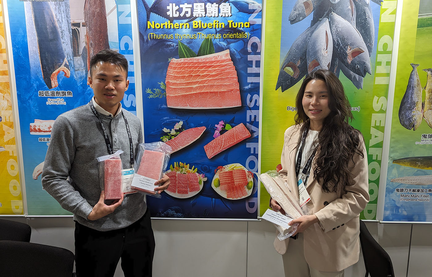 Wen Chi Seafoods employees pose with examples of their products in their booth at Seafood Expo North America