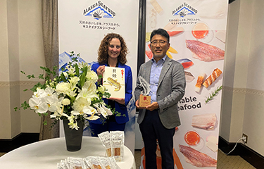 Kawachiya Co President Hajime Kawachi accepts an award for its Shiroebi Kamaboko