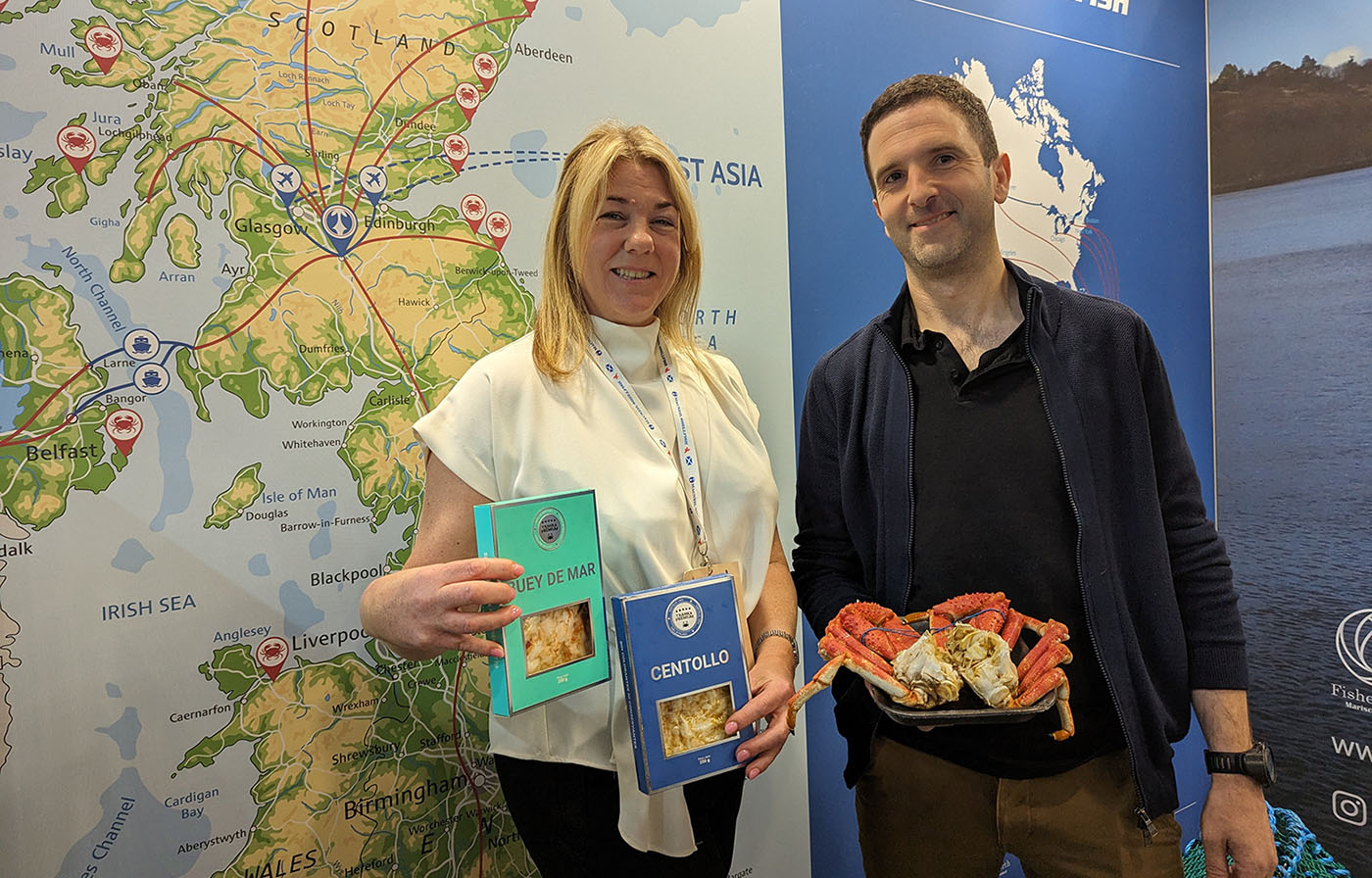 MacNeil Shellfish employees posing with new products at their booth at Seafood Expo Global
