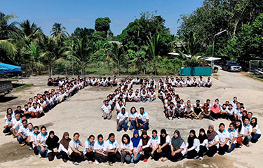 Tuna Paradise's employees pose for a photo on the company's anniversary.