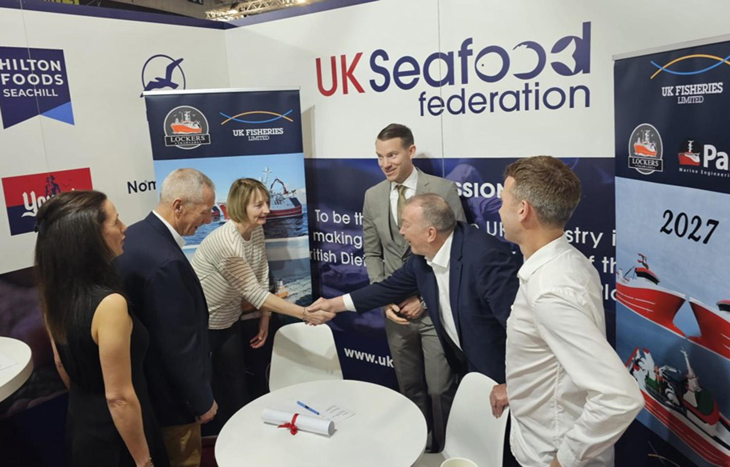 Representatives of UK Fisheries, Lockers Trawlers, and Parkol Marine Engineering shake hands