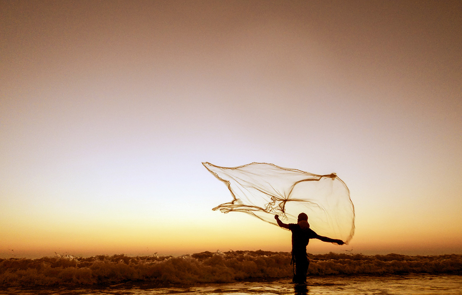 A fisherman throwing a net in Bangladesh