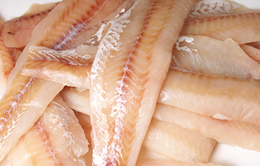 Alaska pollock fillets in a pile.