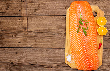 Salmon on a board with citrus