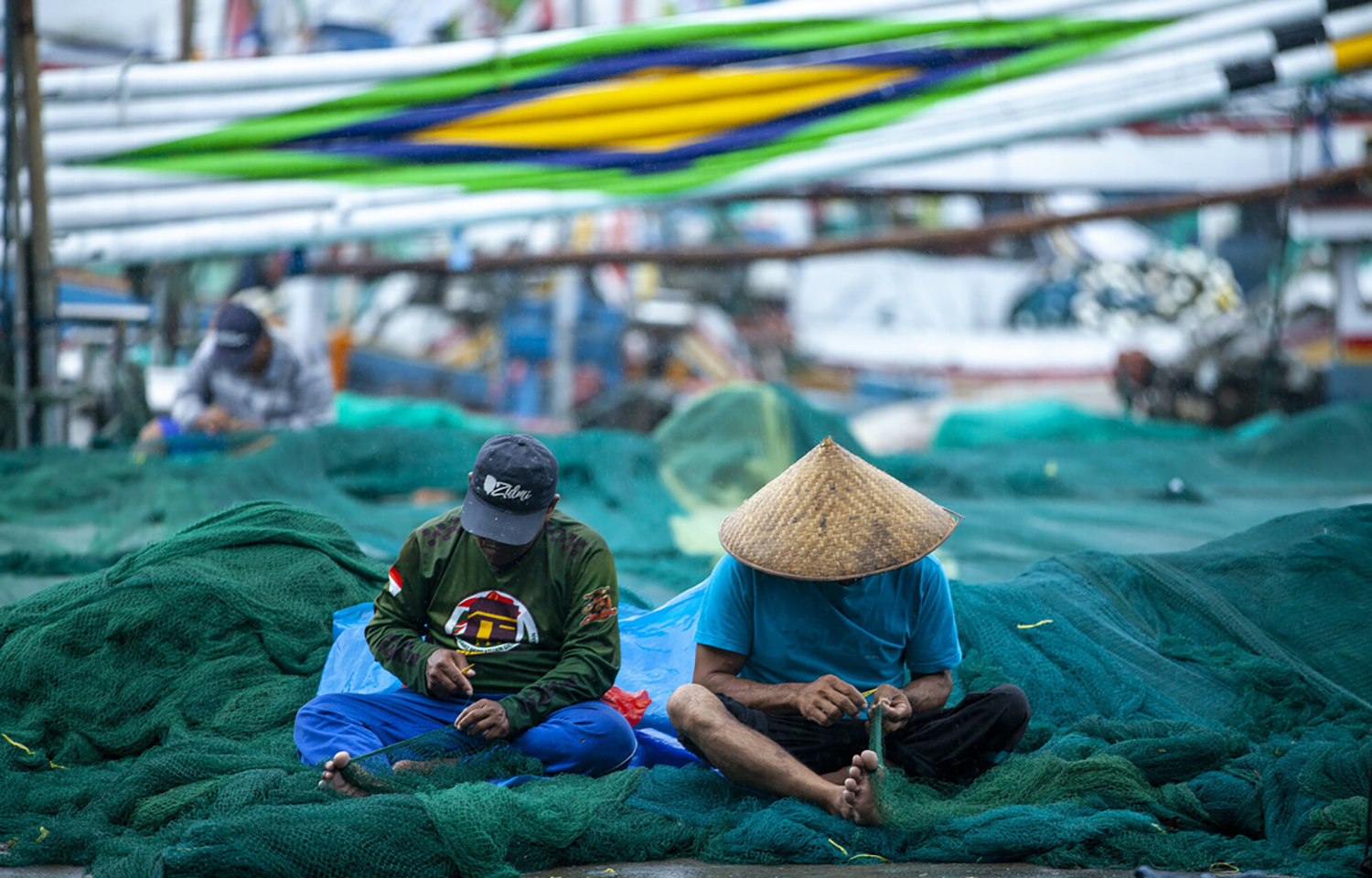 Indonesian fishers untangling netting