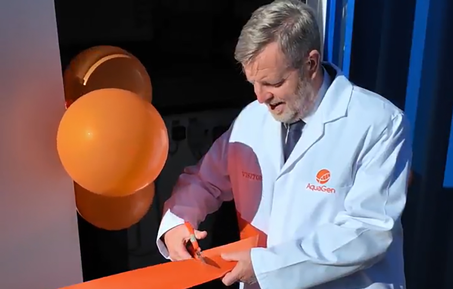 Finlay Carson cutting a ribbon