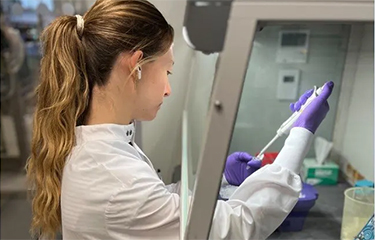A GMGI employee working in a laboratory.
