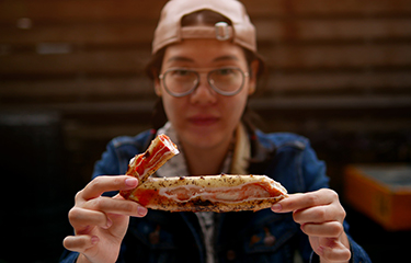 A restaurant-goer eating a king crab leg.