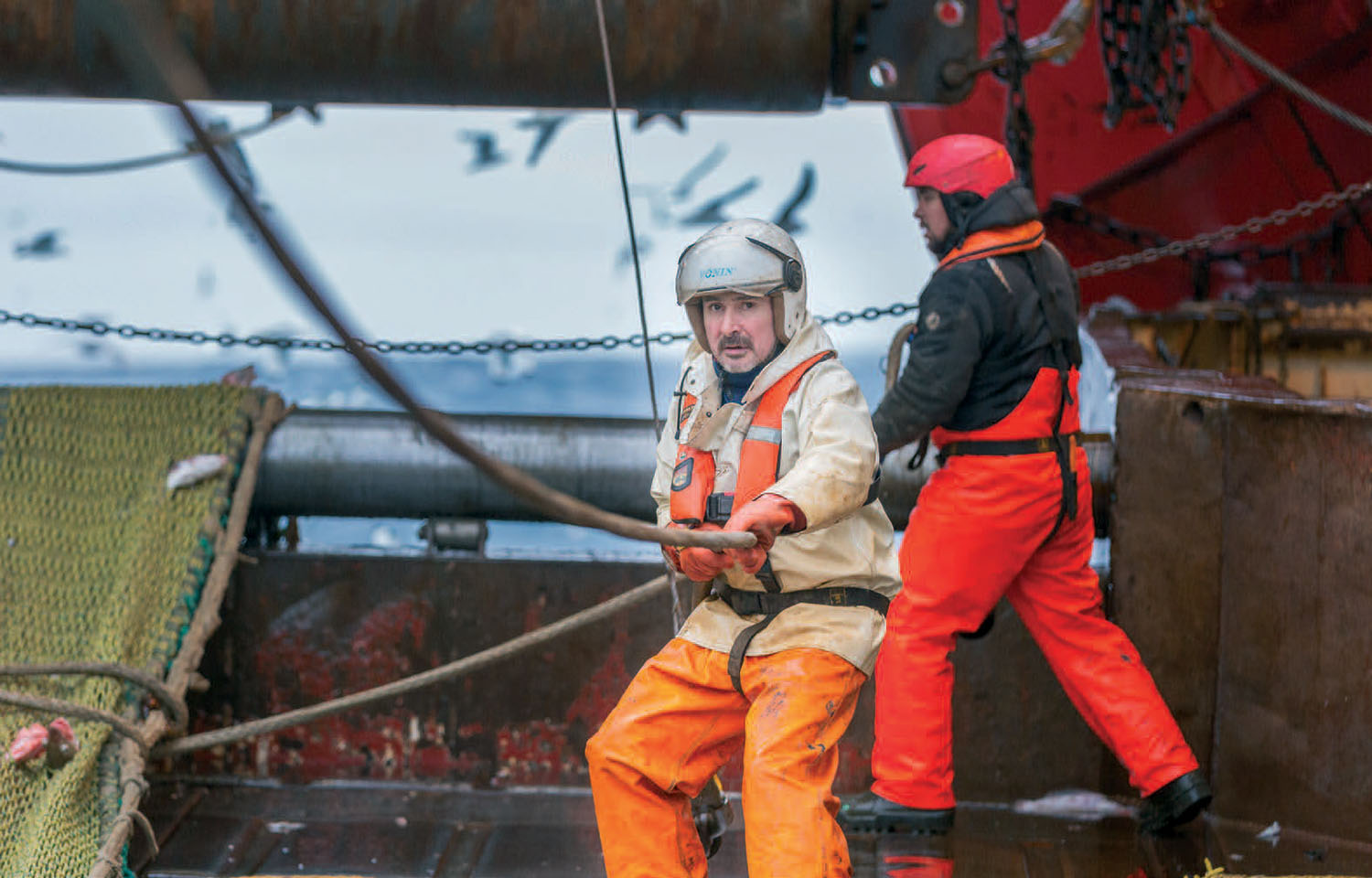 A pair of Polar Seafood fishermen at work on a boat