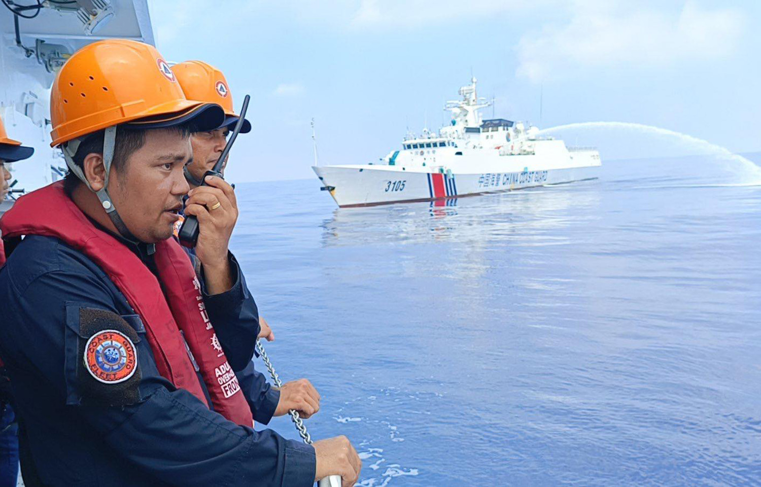 Members of the Philippine Coast Guard interacting with the China Coast Guard in the South China Sea