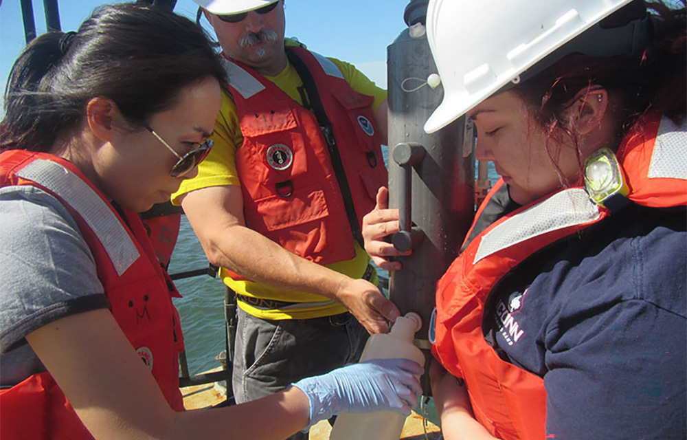Researchers collect water samples for eDNA