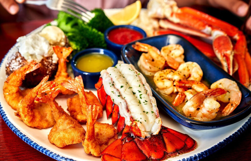 A spread of Red Lobster products including lobster tail, grilled shrimp, and coconut shrimp