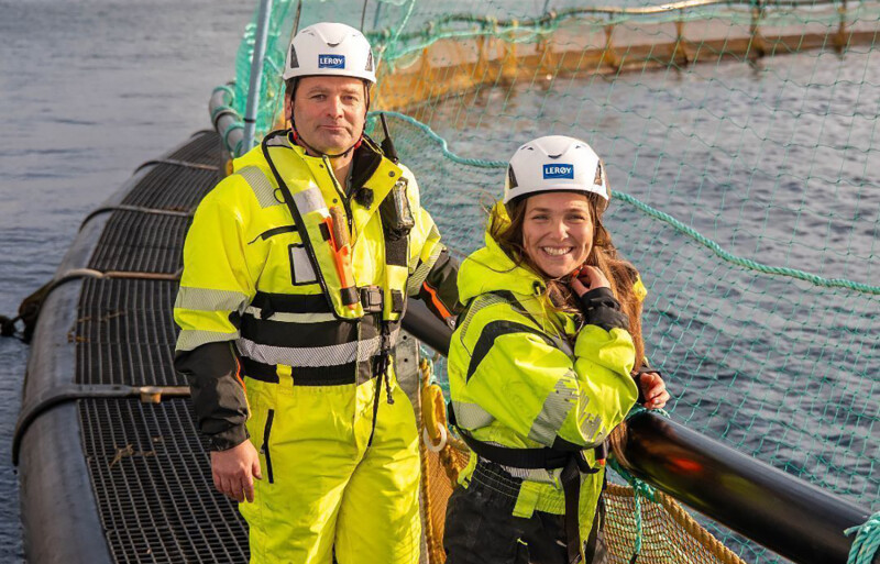 Lerøy Seafood Group employees standing on a net pen