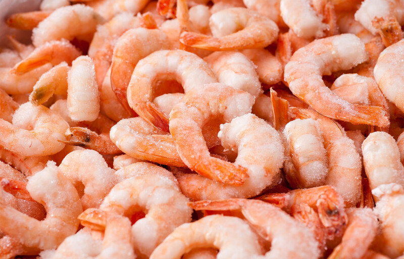 A pile of frozen cooked shrimp