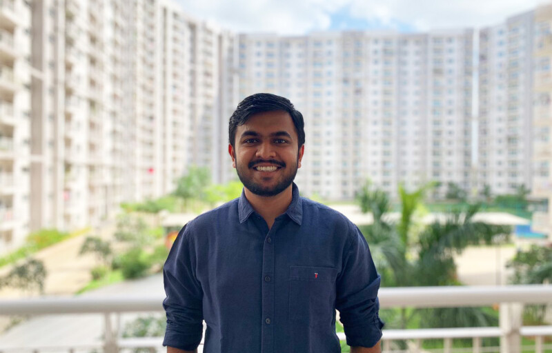 Ankit Alok Bagaria standing on a balcony with buildings in the background