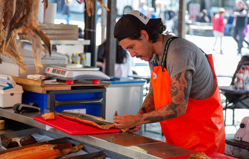 A person selling salmon