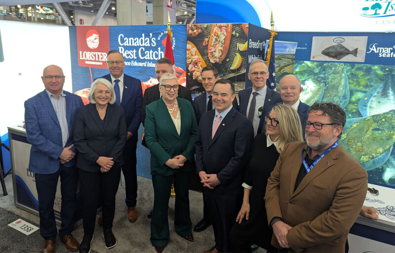 Canadian fisheries ministers pose in a booth at Seafood Expo North America
