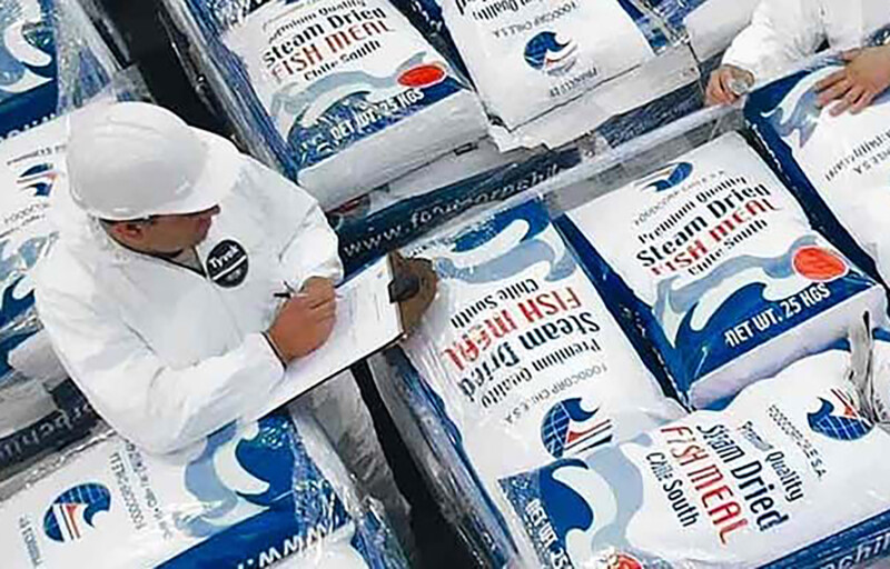 A pile of packaged FoodCorp fishmeal being inspected