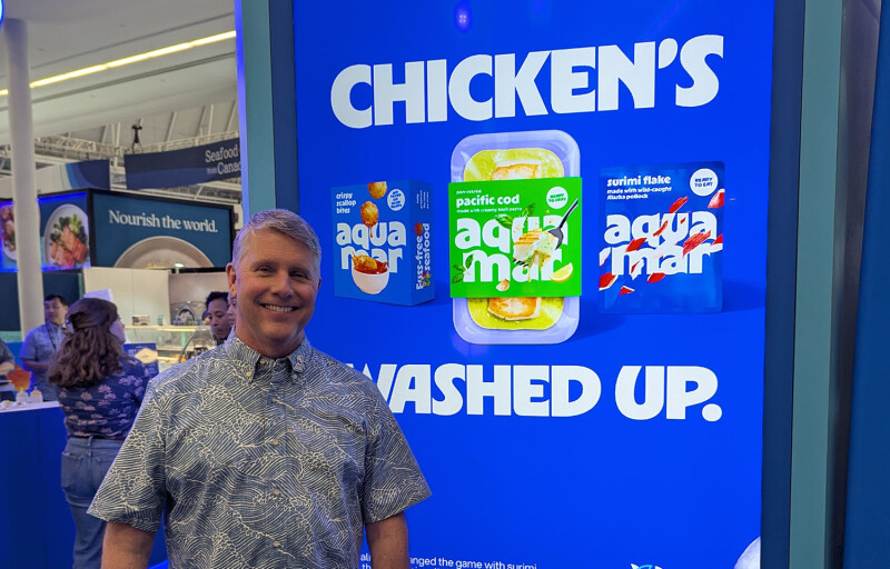 Aquamar CEO Daryl Gormley in front of a sign at Seafood Expo North America