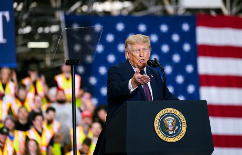 U.S. President Donald Trump giving a speech in front of a flag