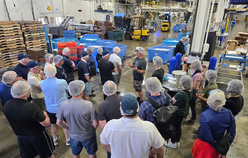 Scottish Fishermen’s Association members standing on a processing facility floor