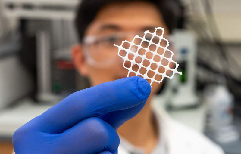 A NC State researcher holding up an example of the fluffy net