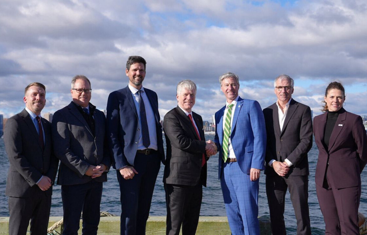 Canada Federal Energy Minister Tim Hodgson shaking hands during a funding announcement for offshore wind