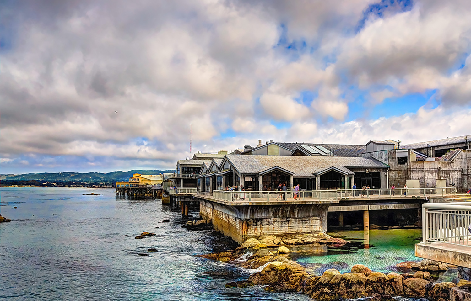 An exterior shot of the Monterey Bay Aquarium, highlighting its proximity to the waters of Monterey Bay
