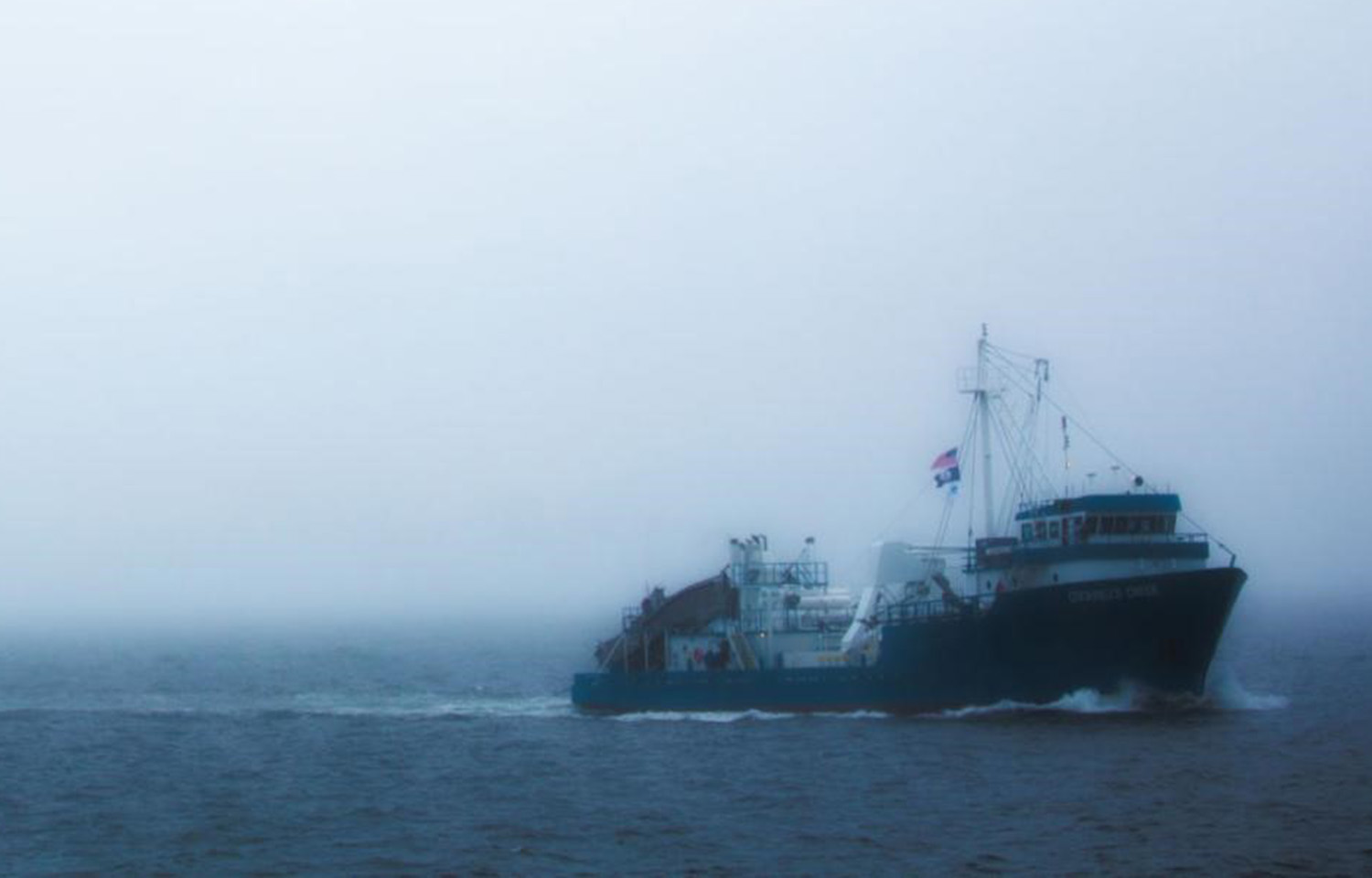 A ship operated by Ocean Harvesters sailing in the fog.