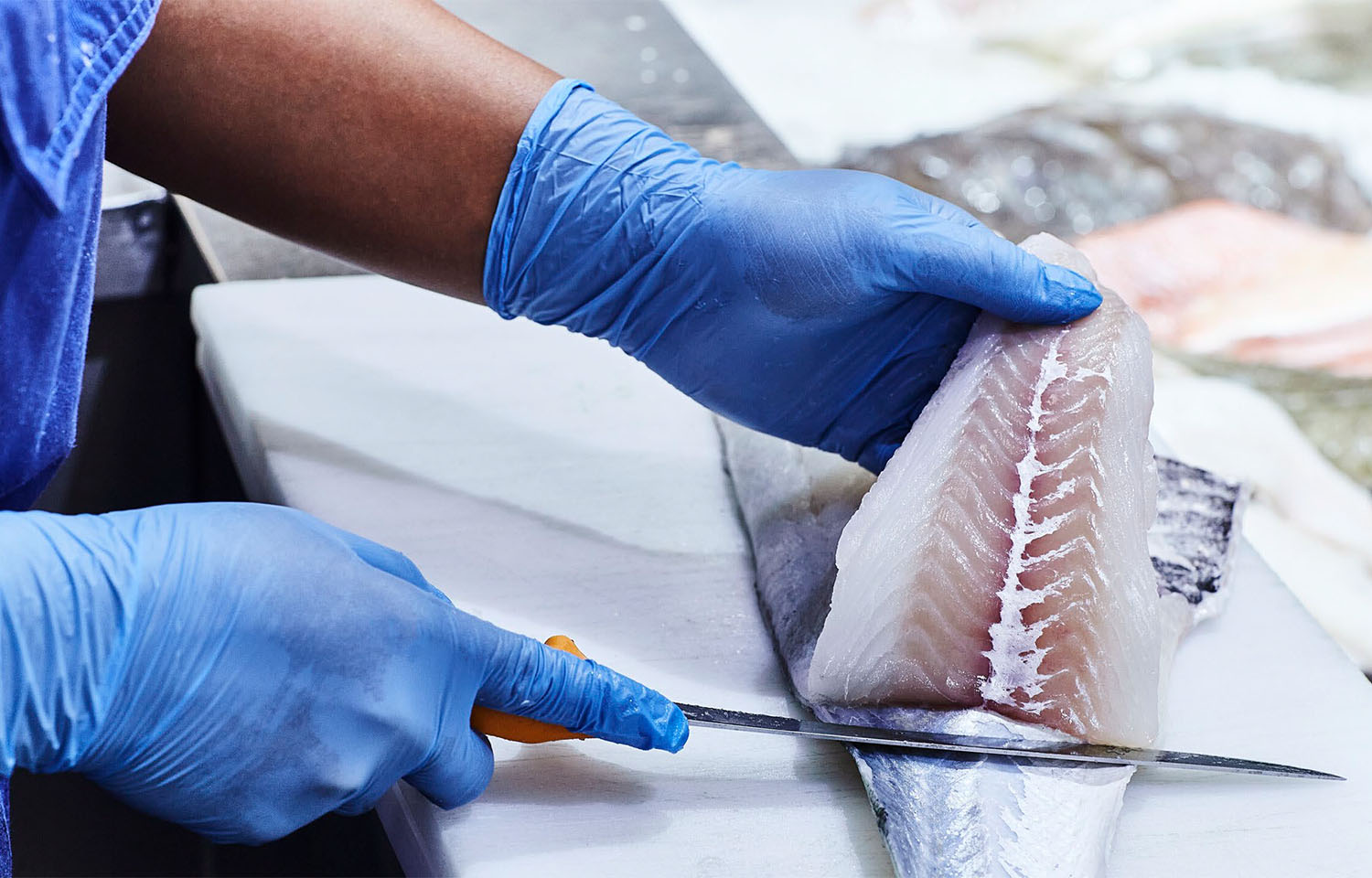 A Norcod employee processing a piece of cod