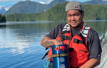 A Creative Salmon employee holding a Biomass Pro unit.