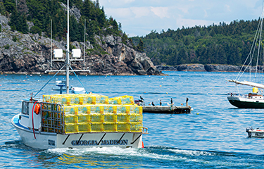 A lobster boat loaded with traps in Bar Harbor, Maine.