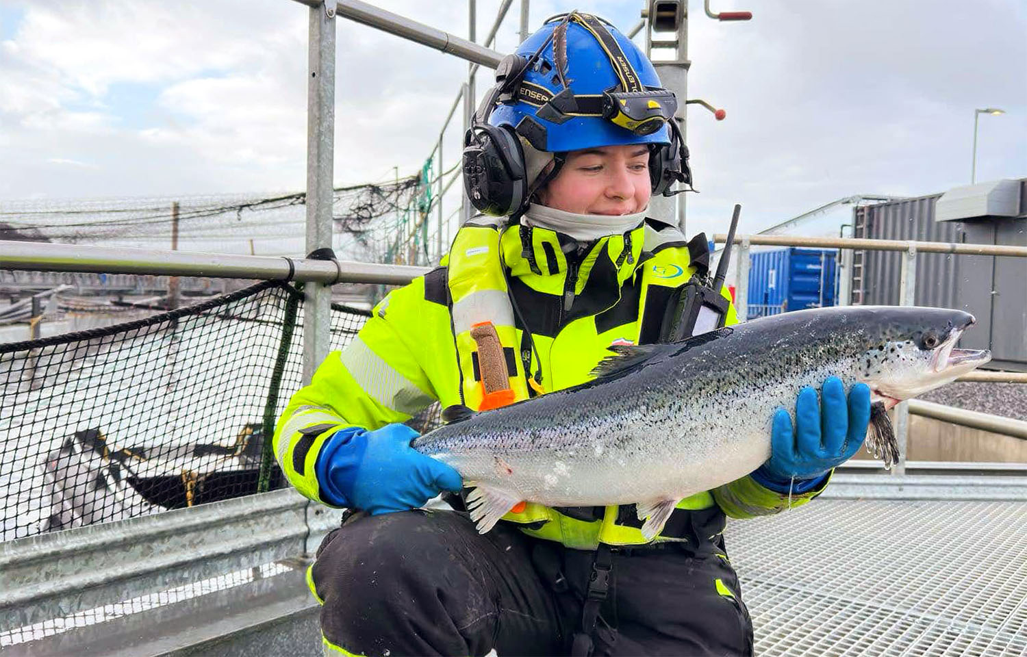 A Gigante Salmon employee holding a salmon