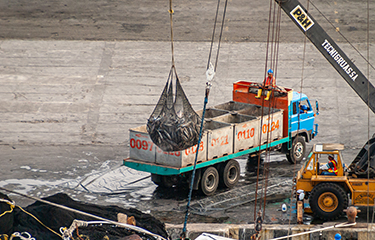 A crane loads tuna onto a truck in Ecuador.