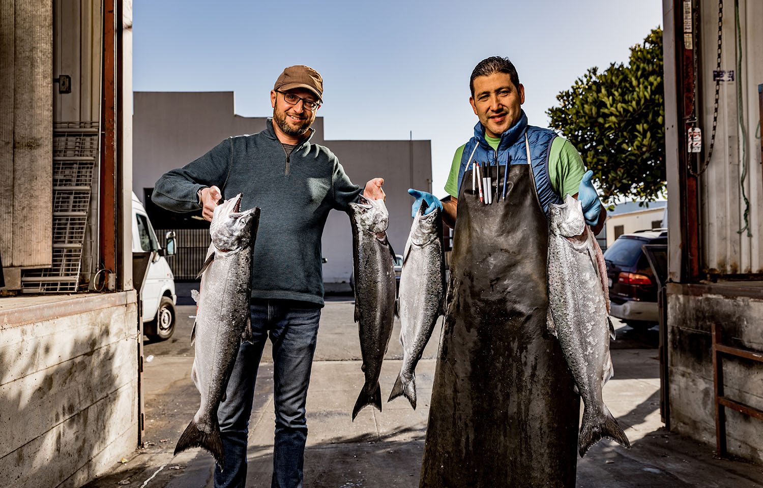 Adrian Hoffman and Ismael Macias posing with large salmon in each hand