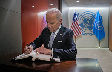 U.S. President Joe Biden signs a guestbook at the United Nations.