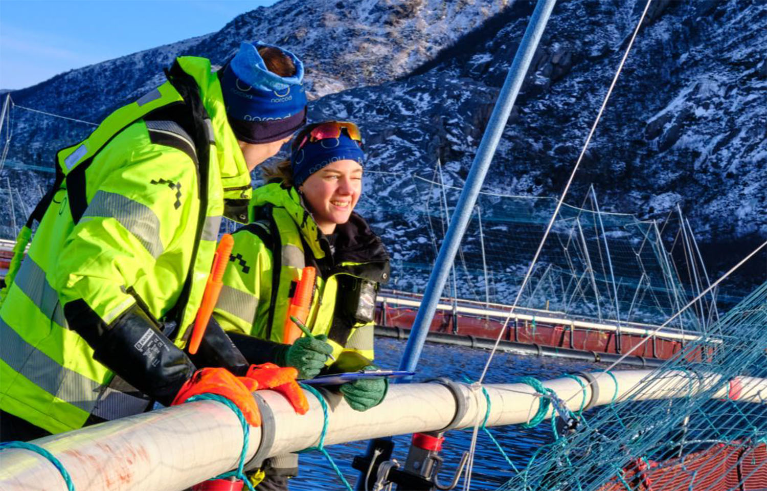 A pair of people on a Norcod net pen